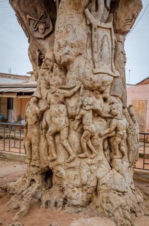 Ouidah, Benin - March 06, 2014: Carved tree trunk in center of town depicting time of slaveryのeditorial素材