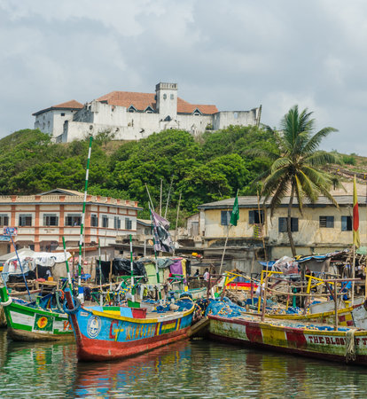 Elmina, Ghana - February 13, 2014: Colorful moored wooden fishing boats in African harbor town Elminaのeditorial素材