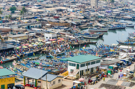 Elmina, Ghana - February 13, 2014: Colorful moored wooden fishing boats in African harbor town Elminaのeditorial素材