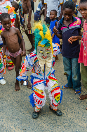 Cape Coast, Ghana - February 15, 2014: Colorful masked and costumed dancer during African carnival festivitiesのeditorial素材