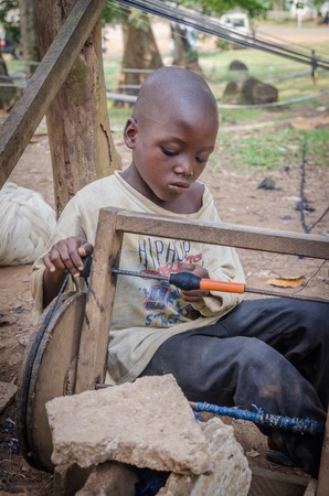 Man, Ivory Coast - January 31,2014: Unidentified African boy weaving traditional Yacouba cloth with strong focusのeditorial素材