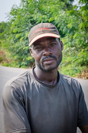 Man, Ivory Coast - January 31,2014: Portrait of unidentified African man with cap looking at camera outdoorsのeditorial素材