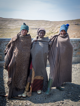 Mokhotlong, Lesotho - September 11, 2016: Three unidentified young African sheperds in traditional thick blanketsのeditorial素材