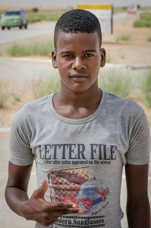 Nouadibhou, Mauritania - September 28, 2013: Portrait of unidentified young man with gray t-shirt posingのeditorial素材