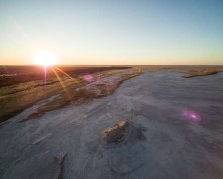 Aerial view of sunset over Tshitane Salt Pan in the salt flats area of Kalahari, Botswana, Africa.の写真素材