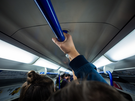 Crowd of people during rush hour in London Tube subway interior, London, United Kingdom.の写真素材