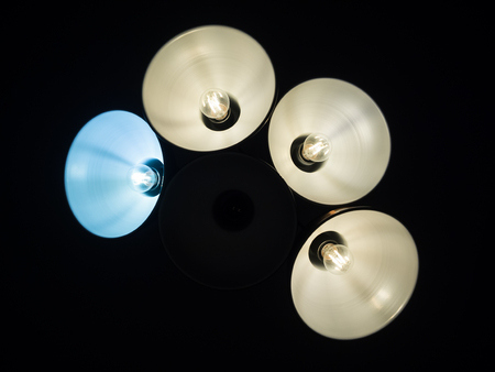 Abstract background with blue and white lamps or lights isolated from black background.の写真素材