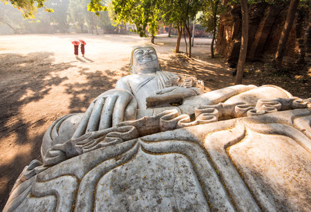 Two monks and reclining marble buddha statue at Mandalayの写真素材