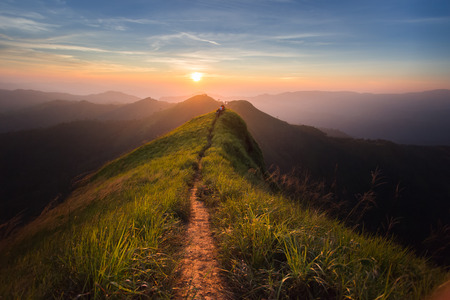 The way of climax. Mountain slope have a way for walk. Background is sunset. The way of climax. Mountain slope have a way for walk. Background is sunset.