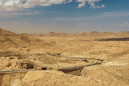 Road passes through rocky Sahara desert, Tunisia.の写真素材