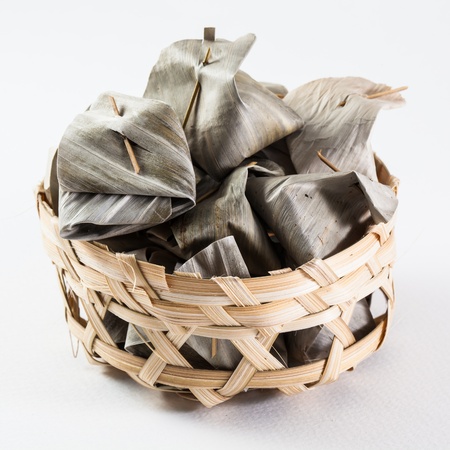 Sweet Thai  traditional dessert cover with banana leaf in bamboo basketの写真素材