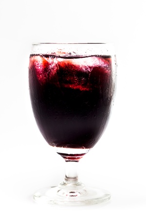 A glass of red grape juice with white isolated background.の写真素材