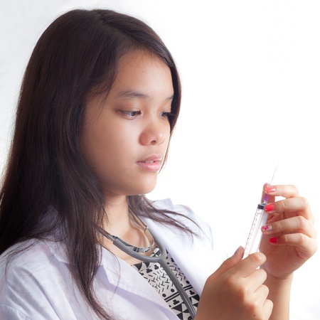 Portrait of young doctor against white backgroundの写真素材