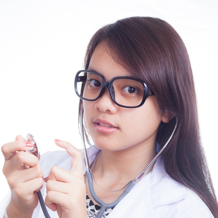 Portrait of young doctor against white backgroundの写真素材