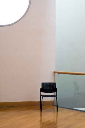 Lonely black chair at the corner of the roomの写真素材
