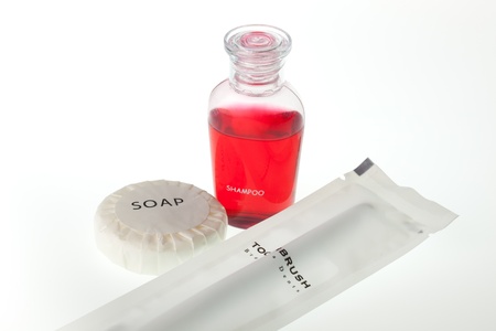 The travelling set, soap, shampoo and tooth brush against white backgroundの写真素材