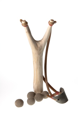 Isolate of wooden slingshot and clay bullets against on white backgroundの写真素材