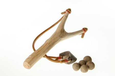 Isolate of wooden slingshot and clay bullets against on white backgroundの写真素材