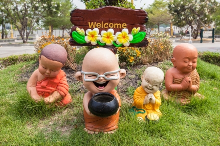 Monk toys on the garden with welcome signの写真素材