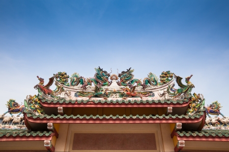 Fantasy animals decorated on the roof of gate in a chineses temple in Thailandの写真素材