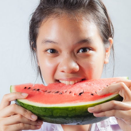 Girl eating water melonの写真素材