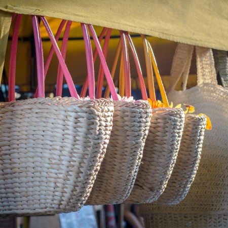 Handicraft bags hanging in row for purchaseingの写真素材