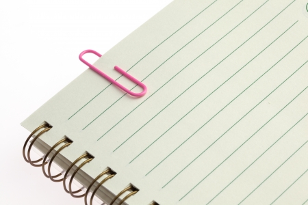 Blank notebook with pink clip placed on white backgroundの写真素材