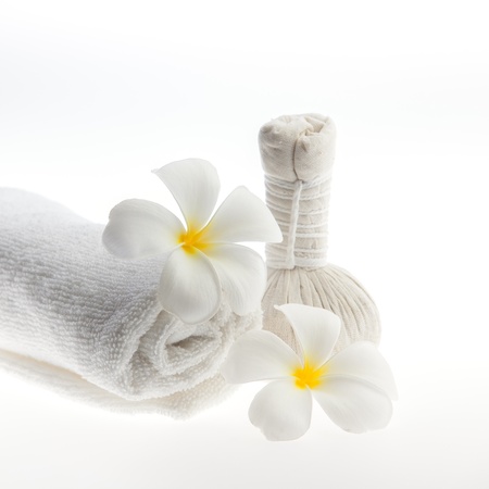 Herb ball beside white towel decorate with white flower against white backgroundの写真素材