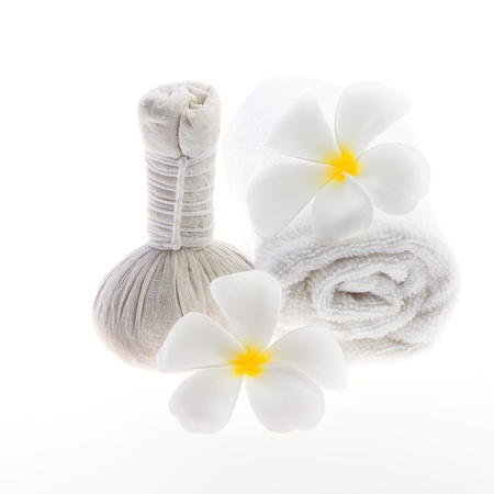 Herb ball beside white towel decorate with white flower against white backgroundの写真素材