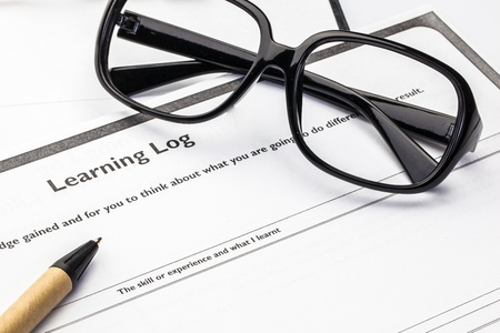 Learning log blank form with glasses and penの写真素材