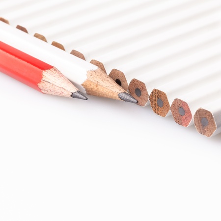 Line of white pencils with red and white pencils out the lineの写真素材