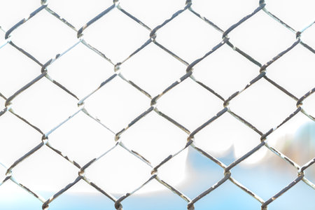 Close up of metal twist fence with orange light background