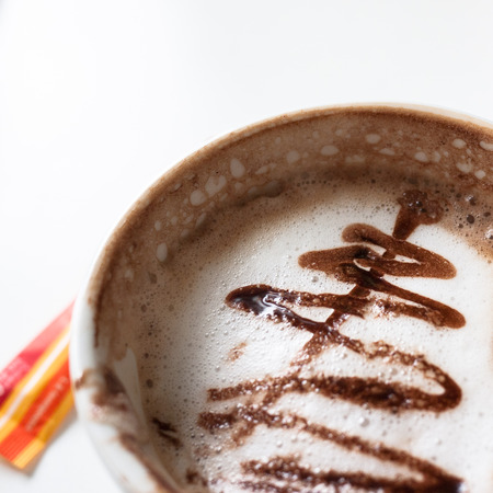 Latte art on coffee cup on white backgroundの写真素材