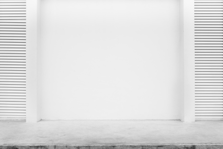 Empty white wall beside concrete pathの写真素材