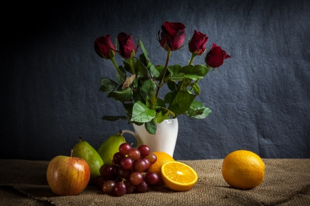 Still life fruits, fresh fruit display in wooden basket and some place on sack clothの写真素材