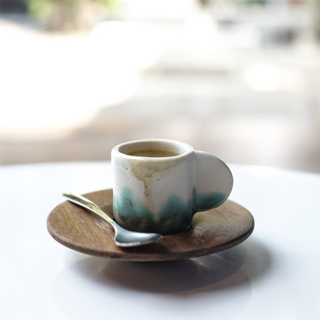 Small cup of coffee on white table with set of sugar potsの写真素材