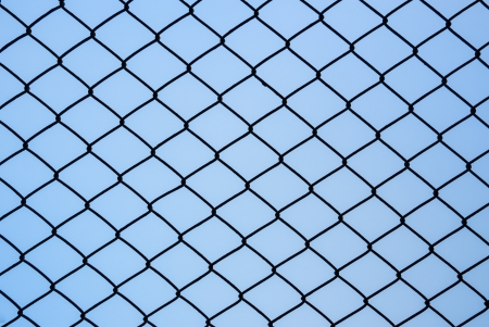 Iron black wire fence on isolated backgroundの写真素材