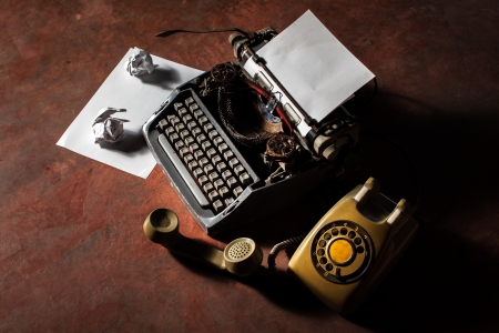 Old English type writer with paper sheet and aged lanternの写真素材
