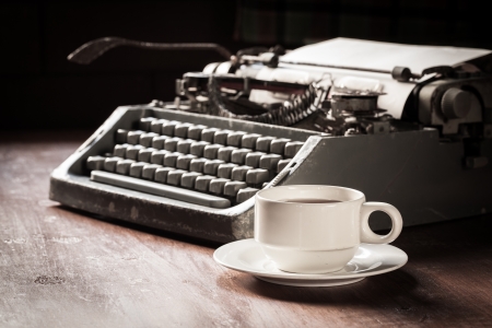 Vintage typewriter and coffee cup on tableの写真素材