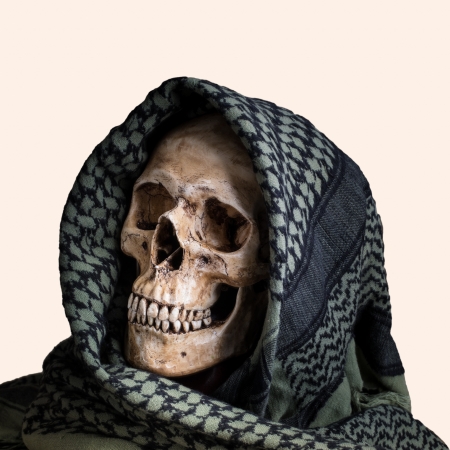 Human skull with shemagh cloth on isolated whiteの写真素材