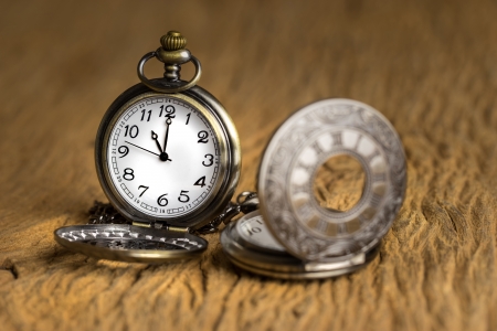 Vintage Antique pocket watch on grunge wooden backgroundの写真素材