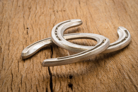 Horse shoes on wooden tableの写真素材