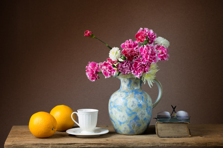 Still life with bunch of flowers and orangesの写真素材