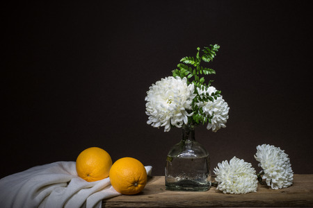 Still life with bunch of flowers and oranges, light painting techniqueの写真素材