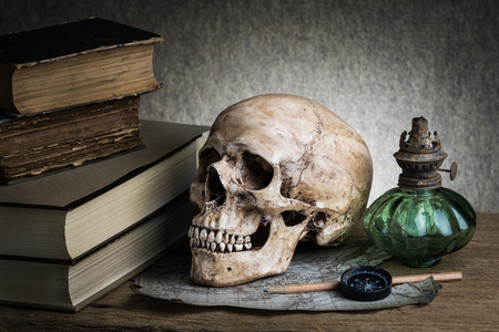 Still life, human skull with compass on torn map and ancient lanternの写真素材