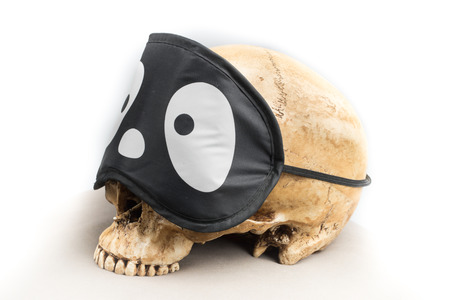 Human skull with funny eyepadの写真素材