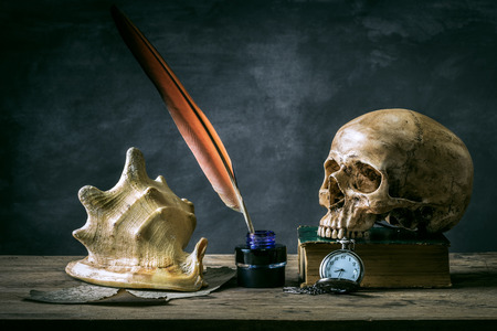 Still life with human skull vintage antique pocket watch and keys on grunge book backgroundの写真素材
