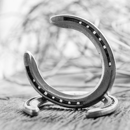 Horse shoes on wooden tableの写真素材