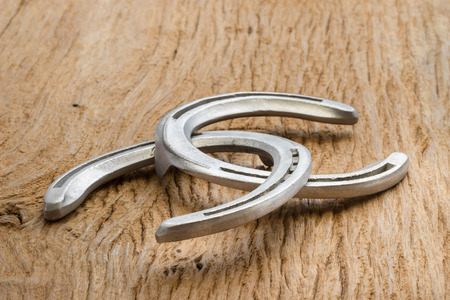 Horse shoes on wooden tableの写真素材