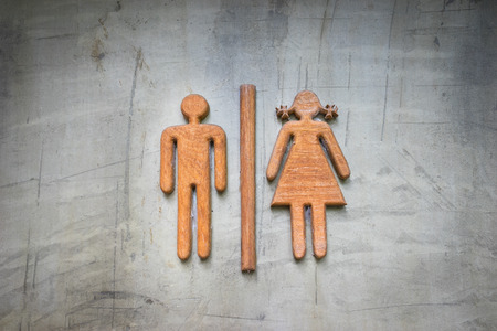 Restroom sign made of teak wood on concrete wallの写真素材